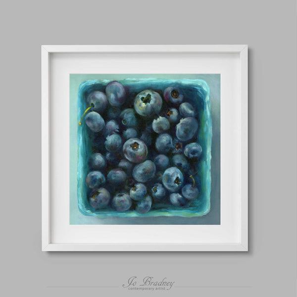 Fresh indigo blueberries in a teal green market box. This archival art print of my summer fruit still life oil painting is shown in simple white picture frame.