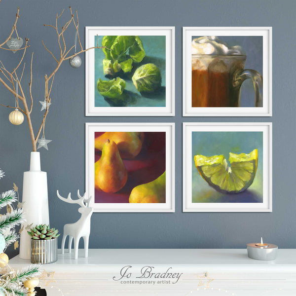 Four Christmas food art prints on a living room wall with an elegant holiday display.  They add a touch of elegance to your seasonal decor in the kitchen, dining room gallery or home bar.
