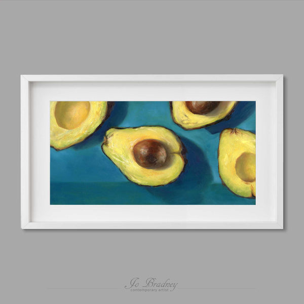 yellow and teal green avocadoart print hanging horizontal. This archival art print of my vegetable still life oil painting is shown in simple white picture frame.