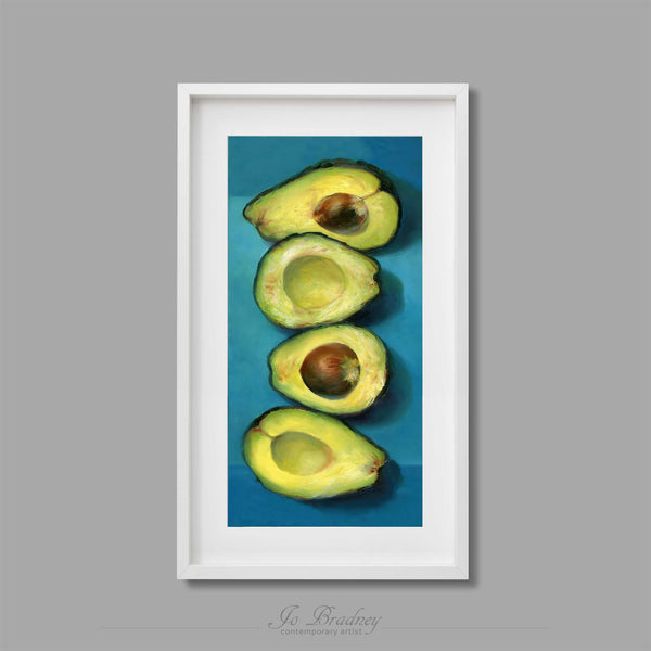 This tall skinny art print of my [avocado still life oil painting is shown in simple white picture frame.