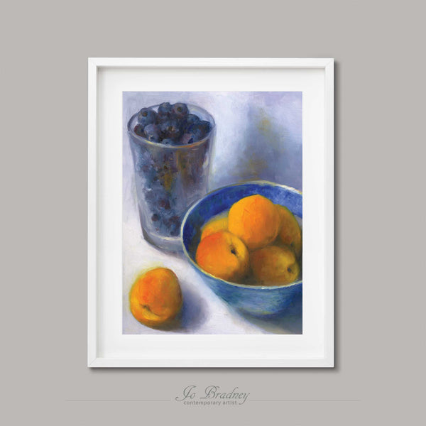 a blue bowl of apricots and a pint glass filled with fresh blueberries. An archival art print of my fruit still life oil painting, shown in simple white picture frame.