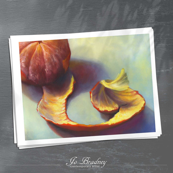 A stack of horizontal art prints on archival paper on a slate kitchen counter. The prints show a peeling clementine spiral. This is a giclee print of my realistic oil painting fruit still life. The original artwork is sold.