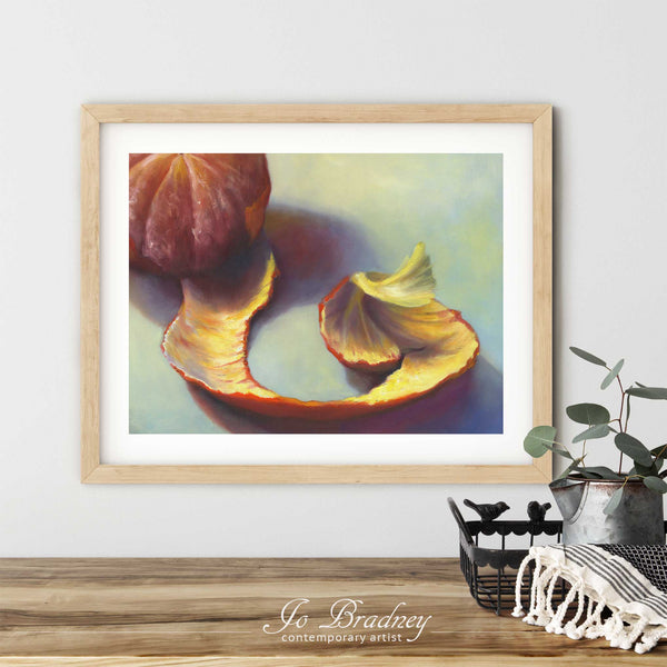 A Christmas clementine art print in a simple, elegant wood picture frame on a dining room or living room wall. There are flowers in a teapot on a metal tray set on a wood table. The smallest horizontal print is 4x6 inches, the largest is 11x14 inches.