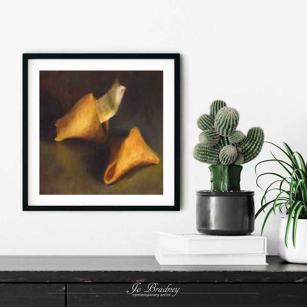 A Chinese fortune cookie oil painting print in a simple, elegant black picture frame on a living room or dining room wall, with a pile of books and a cactus. The print size ranges from 4 to 12 inches square.