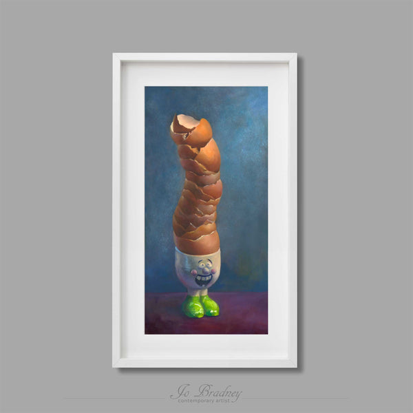 A tower of warm brown eggshells stacked in a grinning egg cup. This archival art print of my food still life oil painting is shown in simple white picture frame.