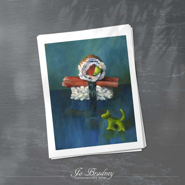 A stack of vertical art prints on archival paper on a slate kitchen counter. The prints show a boy made from sushi rolls with a wasabi dog. This is a giclee print of my realistic oil painting food still life. The original artwork is sold.