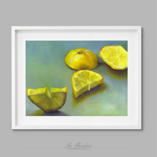 A fresh sliced sunny yellow lemon on a pale blue-green background. This archival art print of my citrus fruit still life oil painting is shown in simple white picture frame.