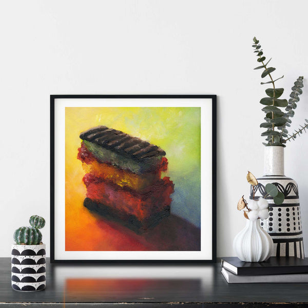 A sweet treat snack food oil painting art print of cake framed in a simple, elegant black picture frame on a dining room or living room wall. There are flowers in vase, set on a wood buffet table. The smallest square print on paper is 4 inches, the largest is 12 inches.