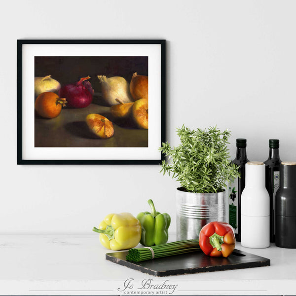 An onion oil painting art print in a simple, elegant black picture frame on a kitchen wall. There is a chopping board, vegetables, herbs and some bottles. The art print is as large as three bell peppers. The largest size is 11 inches high by 14 wide