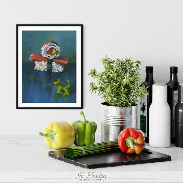 A sushi painting print in a simple, elegant black picture frame on a kitchen wall. There is a chopping board, vegetables, herbs and some bottles. The art print is as large as three bell peppers. The largest size is 14 inches high by 11 wide