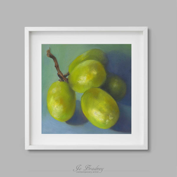 A tiny bunch of green grapes on a pale blue background. This archival square art print of my fruit still life oil painting is shown in simple white picture frame.