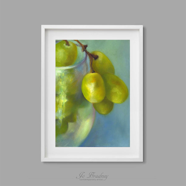 A bunch of green grapes in a wine glass. This archival art print of my fruit still life oil painting is shown in simple white picture frame.